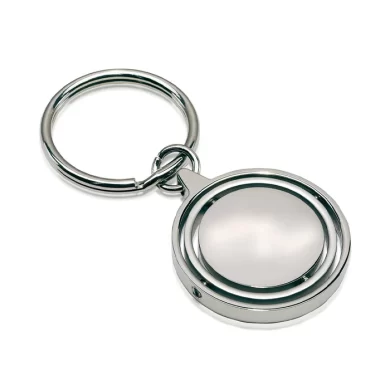 Llavero metálico redondo modelo Terra con superficie central giratoria y estuche de presentación